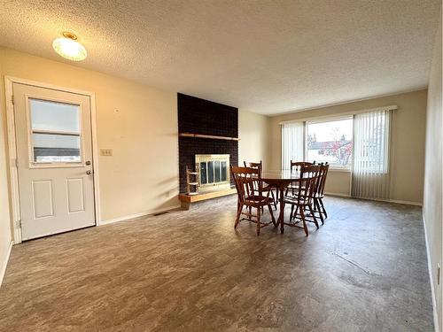 34 Windfall Drive, Whitecourt, AB - Indoor Photo Showing Dining Room With Fireplace