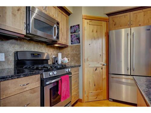 222-107 Armstrong Place, Canmore, AB - Indoor Photo Showing Kitchen With Stainless Steel Kitchen