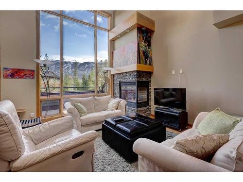 222-107 Armstrong Place, Canmore, AB - Indoor Photo Showing Living Room With Fireplace