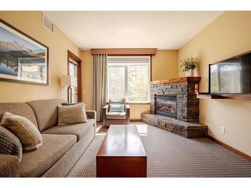 216-190 Kananaskis Way, Canmore, AB - Indoor Photo Showing Living Room With Fireplace