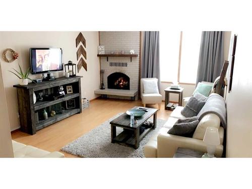 407 5 Street North, Fox Creek, AB - Indoor Photo Showing Living Room With Fireplace