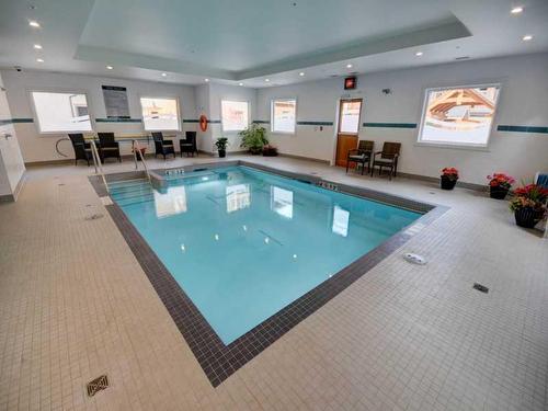 306-808 Spring Creek Drive, Canmore, AB - Indoor Photo Showing Other Room With In Ground Pool