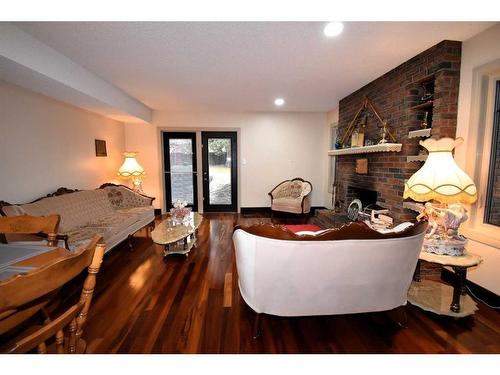 105 Mcpherson Square Square, Hinton, AB - Indoor Photo Showing Living Room With Fireplace