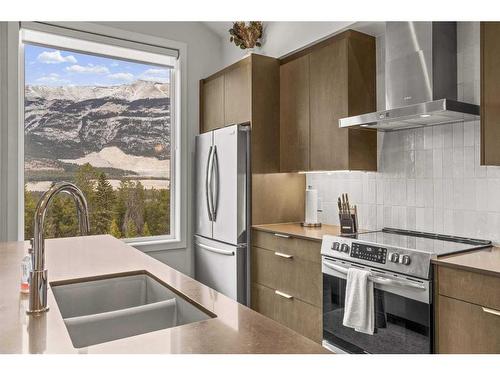 301B-209 Stewart Creek Rise, Canmore, AB - Indoor Photo Showing Kitchen With Stainless Steel Kitchen With Double Sink With Upgraded Kitchen