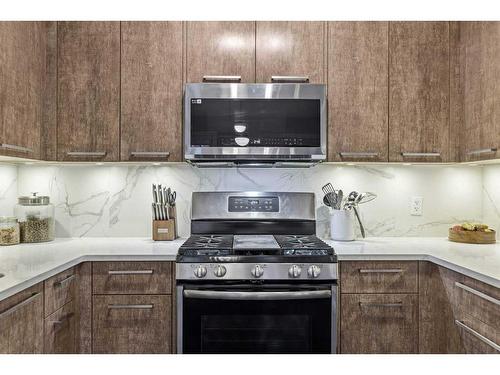 701-102 Stewart Creek Rise, Canmore, AB - Indoor Photo Showing Kitchen With Upgraded Kitchen