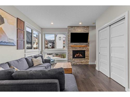 701-102 Stewart Creek Rise, Canmore, AB - Indoor Photo Showing Living Room With Fireplace