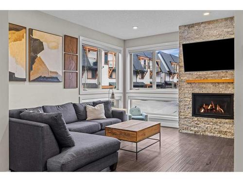 701-102 Stewart Creek Rise, Canmore, AB - Indoor Photo Showing Living Room With Fireplace