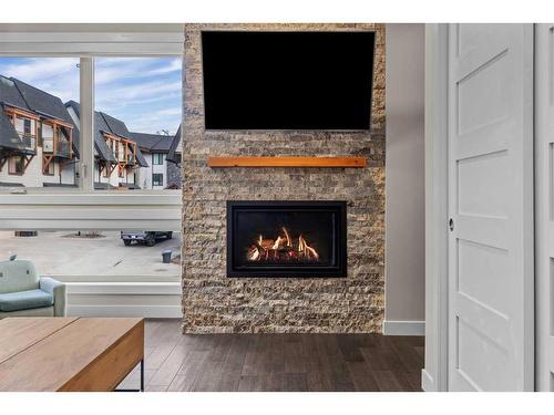 701-102 Stewart Creek Rise, Canmore, AB - Indoor Photo Showing Living Room With Fireplace