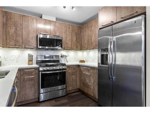 701-102 Stewart Creek Rise, Canmore, AB - Indoor Photo Showing Kitchen With Stainless Steel Kitchen