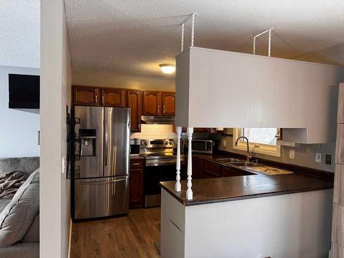 208 Slade Drive, Nanton, AB - Indoor Photo Showing Kitchen With Double Sink