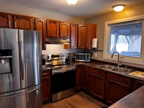 208 Slade Drive, Nanton, AB - Indoor Photo Showing Kitchen With Double Sink