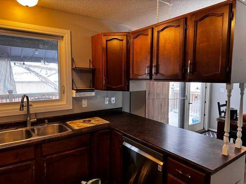 208 Slade Drive, Nanton, AB - Indoor Photo Showing Kitchen With Double Sink