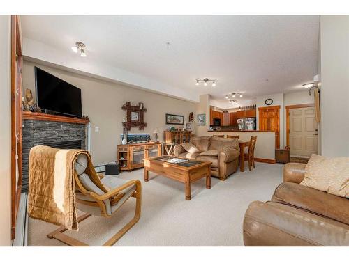 207-155 Crossbow Place, Canmore, AB - Indoor Photo Showing Living Room With Fireplace