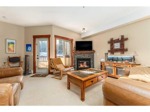 207-155 Crossbow Place, Canmore, AB - Indoor Photo Showing Living Room With Fireplace