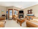 207-155 Crossbow Place, Canmore, AB  - Indoor Photo Showing Living Room With Fireplace 