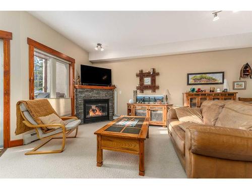 207-155 Crossbow Place, Canmore, AB - Indoor Photo Showing Living Room With Fireplace