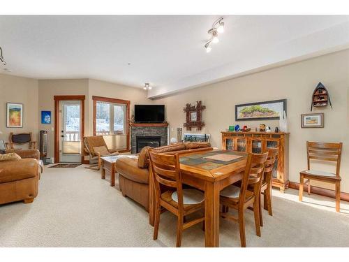 207-155 Crossbow Place, Canmore, AB - Indoor Photo Showing Living Room With Fireplace