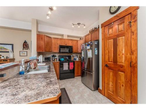 207-155 Crossbow Place, Canmore, AB - Indoor Photo Showing Kitchen With Double Sink