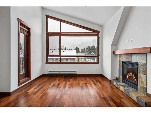 307-1002 8Th Avenue, Canmore, AB - Indoor Photo Showing Living Room With Fireplace