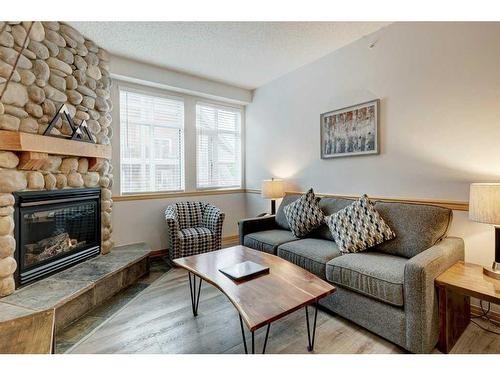 204-1151 Sidney Street, Canmore, AB - Indoor Photo Showing Living Room With Fireplace