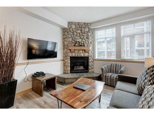 204-1151 Sidney Street, Canmore, AB - Indoor Photo Showing Living Room With Fireplace