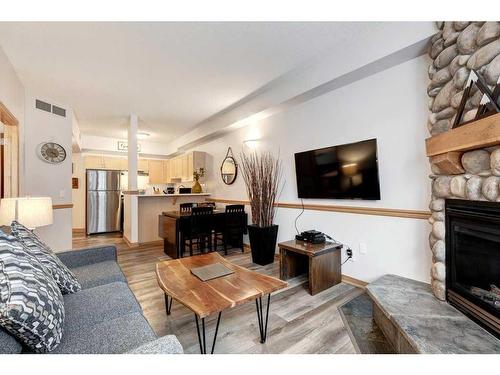 204-1151 Sidney Street, Canmore, AB - Indoor Photo Showing Living Room With Fireplace