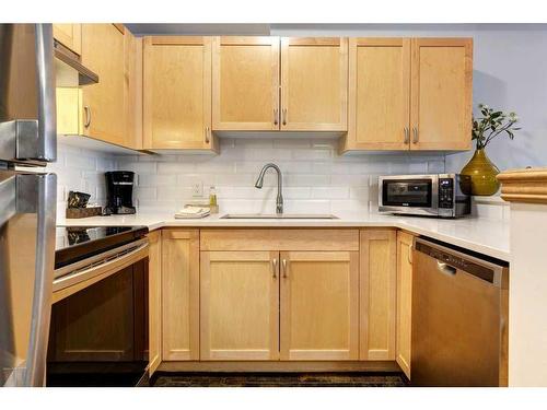 204-1151 Sidney Street, Canmore, AB - Indoor Photo Showing Kitchen With Stainless Steel Kitchen