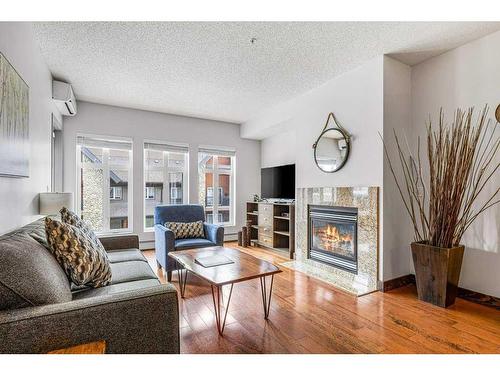 306-1151 Sidney Street, Canmore, AB - Indoor Photo Showing Living Room With Fireplace