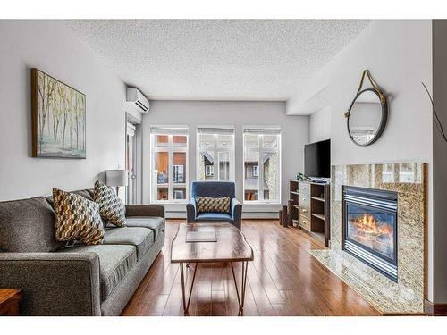 306-1151 Sidney Street, Canmore, AB - Indoor Photo Showing Living Room With Fireplace