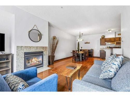 306-1151 Sidney Street, Canmore, AB - Indoor Photo Showing Living Room With Fireplace