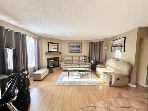 703 3 Avenue, Fox Creek, AB - Indoor Photo Showing Living Room With Fireplace