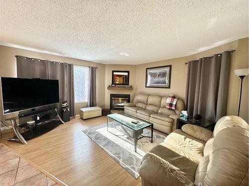 703 3 Avenue, Fox Creek, AB - Indoor Photo Showing Living Room With Fireplace