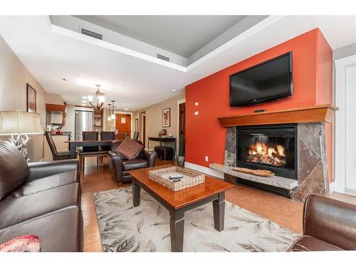 121-173 Kananaskis Way, Canmore, AB - Indoor Photo Showing Living Room With Fireplace