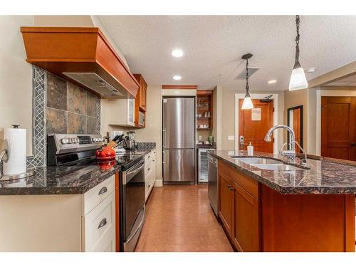 121-173 Kananaskis Way, Canmore, AB - Indoor Photo Showing Kitchen With Double Sink