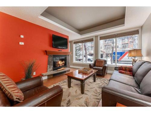 121-173 Kananaskis Way, Canmore, AB - Indoor Photo Showing Living Room With Fireplace