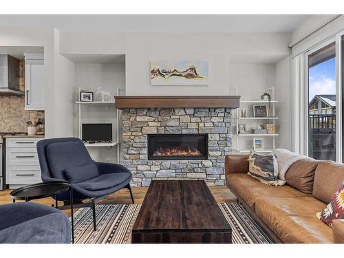 103A-1101 Three Sisters Parkway, Canmore, AB - Indoor Photo Showing Living Room With Fireplace