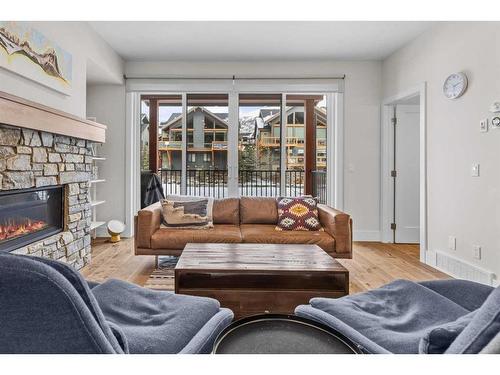 103A-1101 Three Sisters Parkway, Canmore, AB - Indoor Photo Showing Living Room With Fireplace