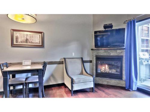 219-901 Mountain Street, Canmore, AB - Indoor Photo Showing Dining Room With Fireplace