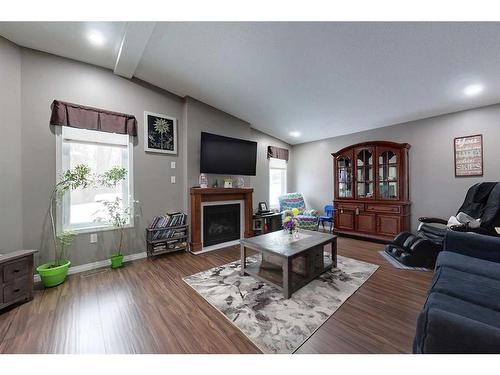 1217 Southshore Drive West, Canyon Creek, AB - Indoor Photo Showing Living Room With Fireplace