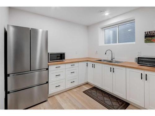 188 Emberside Hollow, Cochrane, AB - Indoor Photo Showing Kitchen With Double Sink