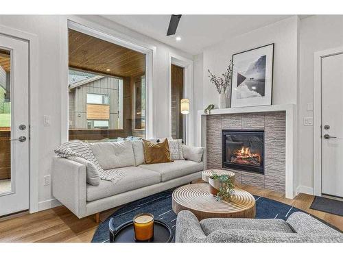 201F-209 Stewart Creek Rise, Canmore, AB - Indoor Photo Showing Living Room With Fireplace