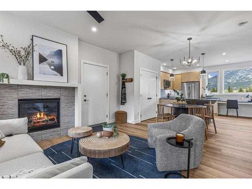 201F-209 Stewart Creek Rise, Canmore, AB - Indoor Photo Showing Living Room With Fireplace