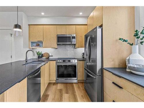 201F-209 Stewart Creek Rise, Canmore, AB - Indoor Photo Showing Kitchen With Double Sink With Upgraded Kitchen