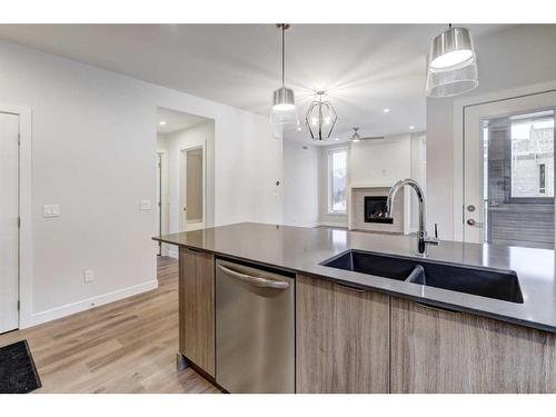 202F-209 Stewart Creek Rise, Canmore, AB - Indoor Photo Showing Kitchen With Double Sink With Upgraded Kitchen