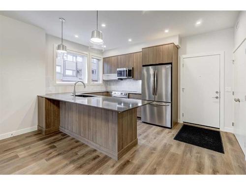 202F-209 Stewart Creek Rise, Canmore, AB - Indoor Photo Showing Kitchen With Upgraded Kitchen