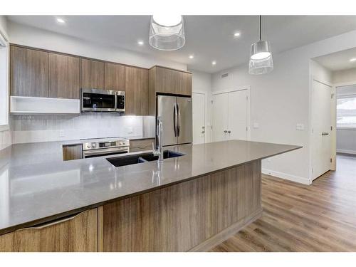 202F-209 Stewart Creek Rise, Canmore, AB - Indoor Photo Showing Kitchen With Double Sink With Upgraded Kitchen