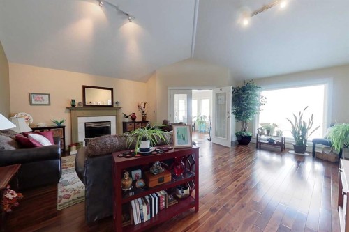 30 Executive Estates, Canyon Creek, AB - Indoor Photo Showing Living Room With Fireplace