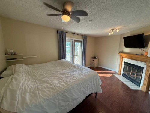 106 West River Road, Hinton, AB - Indoor Photo Showing Bedroom With Fireplace