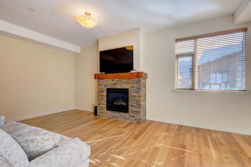 203-901 8Th Avenue, Canmore, AB - Indoor Photo Showing Living Room With Fireplace