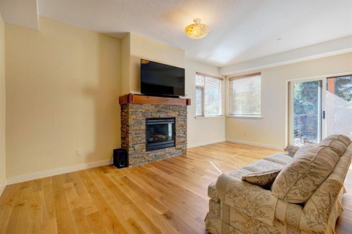 203-901 8Th Avenue, Canmore, AB - Indoor Photo Showing Living Room With Fireplace